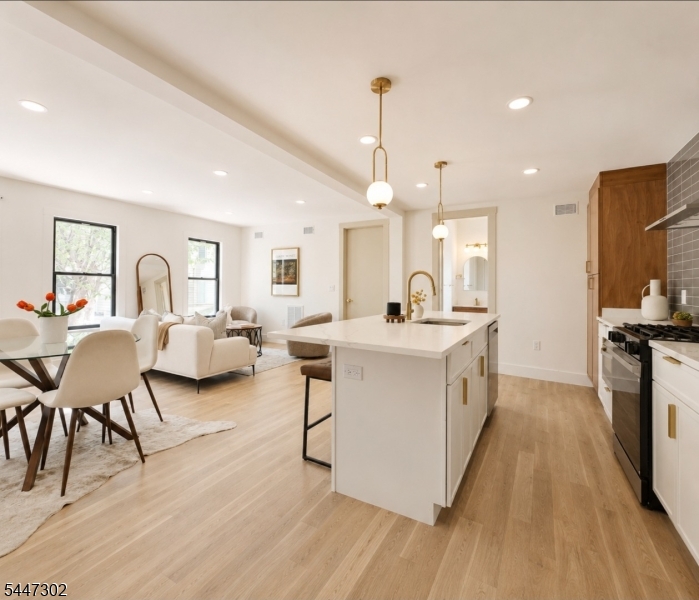 Rare opportunity to own a true single-family home in the highly sought-after Jersey City Heights no condo fees, just modern luxury, privacy, and incredible curb appeal. This bright and sunny home features 3 bedrooms and 3 full ensuite bathrooms, including a first-floor bedroom perfect for guests or flexible living. Step inside to an open-concept layout showcasing oversized 8-foot doors, skylights, designer finishes, and abundant natural light throughout. The stunning chef-inspired kitchen flows seamlessly into the living and dining areas, creating the perfect space for entertaining and everyday living. Enjoy a finished basement ideal for additional living space, gym, office, or media room, along with a private deck directly off the bedroom for your own peaceful retreat. Located in a prime Jersey City Heights community near parks, shopping, restaurants, Light Rail, PATH, buses, and direct NYC transportation a true commuter's dream.