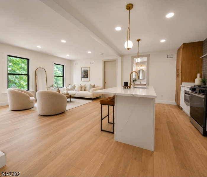 Rare opportunity to own a fully renovated true single-family home in the highly sought-after Jersey City Heights?no condo fees, just modern luxury, privacy, and low-maintenance living.This bright and beautifully designed residence offers three bedrooms and three full ensuite bathrooms, including a convenient first-floor bedroom ideal for guests, a home office, or flexible living. The open-concept interior features oversized 8-foot doors, skylights, gleaming hardwood floors, custom California Closets, high-end designer finishes, and abundant natural light throughout.At the heart of the home, the chef-inspired kitchen flows seamlessly into the living and dining areas, creating an inviting space for entertaining and everyday living. The finished basement provides valuable additional space for a family room, gym, office, or media room. A private deck directly off the bedroom offers a peaceful outdoor retreat.Ideally located near parks, shopping, restaurants, the Light Rail, PATH, buses, and direct transportation to New York City, this exceptional home delivers the perfect combination of style, comfort, convenience, and incredible curb appeal.