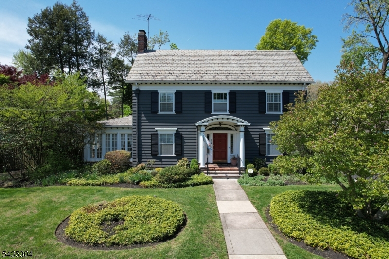 The Banker's Estate: Timeless Architecture Meets Modern Living.  972 Kensington Avenue presents a rare opportunity to own a distinguished Colonial Revival residence rich in character, craftsmanship, and history. Set on beautifully landscaped grounds, this stately home offers approximately 3,500 square feet of living space with 5 bedrooms, multiple baths across three finished levels, and a thoughtfully preserved layout designed for entertaining and comfortable living. A gracious foyer welcomes you with Waterford sconces and timeless architectural detail. Gleaming hardwood floors, expansive formal living and dining rooms, and a classic butler's pantry showcase the home's enduring charm and functionality. Sunlight fills the spectacular sunroom through walls of windows, creating a bright retreat overlooking the property.  The updated kitchen blends historic warmth with modern convenience, featuring Thermador double ovens, adjoining butler's pantry, wet bar, and a convenient secondary stairwell to the second floor. Additional highlights include exceptional closet and storage space throughout, including cedar-lined closets, central air on the second and third floors, and a finished basement with an additional bath and flexible recreation space.  Rare original details including the slate roof, preserved architectural elements, and original 1926 blueprints reflect exceptional craftsmanship rarely found today. A home of this pedigree, scale, and provenance seldom becomes available.