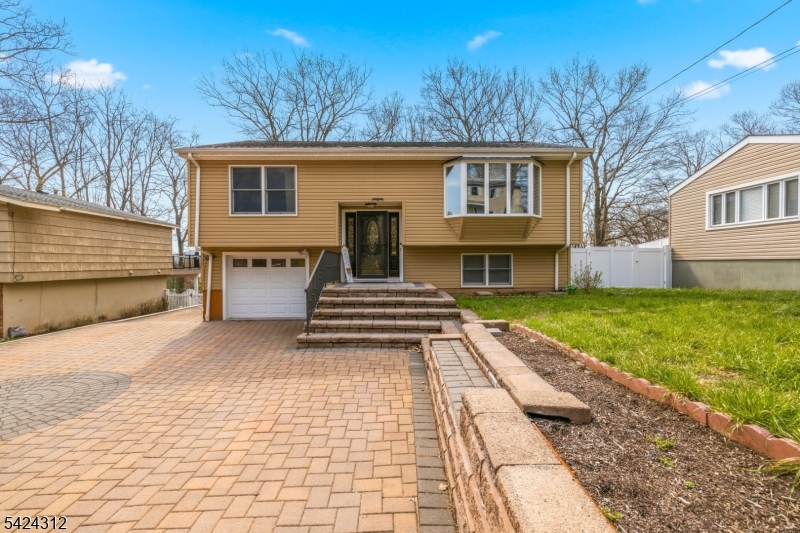 This  spacious updated bi-level home offers 6 bedrooms, 2 full bathrooms, and 2 half baths, providing plenty of room for comfortable living and entertaining. The main level features an open concept living and dining area that seamlessly flows into the kitchen, creating a bright and inviting space. Four generously sized bedrooms and beautiful wood flooring complete this level. The kitchen includes a sliding door that leads to a beautifully appointed deck perfect for outdoor dining and relaxation. The ground level continues the open-concept design with a large family room, recreation room, and two additional bedrooms. The family room opens directly to a lovely patio, offering easy access to the backyard. The fully fenced backyard is ideal for entertaining, featuring a fire pit, storage shed, and ample space for gatherings. Conveniently located near major highways, shopping, and schools, this home combines space, comfort, and IS TRULY A GEM.