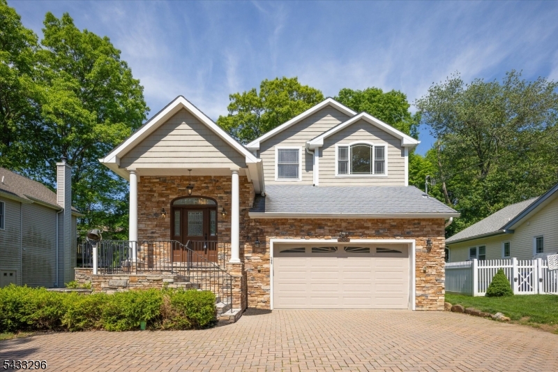Beautifully maintained custom home in the White Meadow Lake community featuring impressive curb appeal with stone exterior accents, a paver driveway, and welcoming covered entry. Inside, the home offers a bright open layout with soaring ceilings, oversized windows, and spacious living areas designed for both everyday living and entertaining.The updated kitchen features granite countertops, stainless steel appliances, custom cabinetry, center island with beverage refrigerator, and open flow into the dining and living spaces. The home offers 4 bedrooms and 3.5 baths, including beautifully renovated bathrooms with high-end finishes and spa-like details. The stunning primary bath showcases a custom glass-enclosed shower, soaking tub, and elegant tilework.Enjoy outdoor living with a large rear deck overlooking the level backyard, offering plenty of space for entertaining, recreation, or relaxing outdoors. Additional features include central air, ample storage, and an attached garage.Located in the White Meadow Lake community, residents enjoy access to private beaches, boating, fishing, swimming, pools, clubhouse, sports courts, playgrounds, and year-round community events, all while remaining close to shopping, dining, major highways, and NJ Transit.