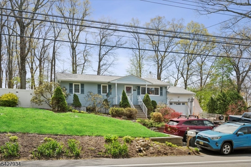 Welcome to this inviting home that blends comfort, space, and convenience.  Inside, you'll find a bright, spacious living area perfect for both relaxing and entertaining.     This home also features three well-sized bedrooms, updated Kitchen, and formal dining room.   Basement features: laundry room, full updated bathroom, Den/office or a 4th bedroom.  Additional livable space, ideal for a family room or guest area.  Step outside to enjoy a large deck perfect for morning coffee or gatherings overlooking a generous backyard with plenty of room to play or garden. An extra-sized  new garage offers ample space for parking, 9 foot door, storage, or hobbies. Conveniently located close to all major highways, this home offers easy commuting while being part of a highly sought-after Blue Ribbon school district. With its combination of updates, functional layout, and outdoor appeal, this home is full of opportunity and ready to welcome its next owner.
