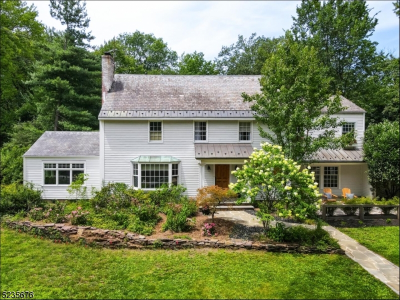 Embrace the serenity of this New England-Style Farmhouse Colonial nestled on a double lot size in the desirable heart of Upper Montclair. This rare gem offers 3,400 sqft. of refined living space, perfectly blending classic allure w/ modern upgrades across 6 bedrooms & 4.5 bathrooms.The winding stone path guides you to the front entrance, framed by natural bamboo w/ custom planters. The 400-sqft. bluestone paver patio creates a suburban sanctuary for peaceful relaxation. Step inside to red & white oak flooring, sophisticated millwork, French-style doors, in-swing windows, gas & electric fireplaces among other features. The formal living room, graced w/ a bay window & marble-framed fireplace, welcomes you home. Further enhancing the first floor is the airy, light-filled LR w/ exposed beam ceilings & built-in bookcases. The gourmet chef's kitchen features top-tier stainless steel appliances, maple cabinetry & limestone countertops, flowing into the screened-in porch for al fresco dining.The main floor also hosts a powder room, office suite & playroom, offering diverse usage. The nearly acre exterior further enhances the home's curb appeal w/ copper roof detailing & snow melter, 3 decks, 2 stone patios, an outdoor fireplace, heated pool, & B-ball court. A pea gravel winding driveway designed by Landscape Techniques offers ample parking. With Yantacaw Park's tranquility at your doorstep and minutes from shopping, dining & NJ Transit, explore this dream home's unmatched features.