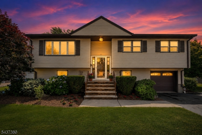 Welcome to this beautifully maintained bi-level home situated on a circular cul-de-sac in a desirable non-flood zone of Little Ferry. This move-in ready home features 4 bedrooms, 1.5 baths, and a versatile layout designed for today's lifestyle. The freshly painted upper level showcases hardwood floors, elegant crown molding, abundant natural light, and spacious living and dining rooms perfect for everyday living and entertaining. The bright eat-in kitchen features updated cabinetry and appliances and opens directly to a large deck overlooking the backyard, creating a seamless indoor-outdoor flow. Three generously sized bedrooms and a full bath complete the main level. The lower level offers a fourth bedroom, half bath, laundry area, one-car garage, and a comfortable family room with sliding glass doors leading to the backyard, providing flexible space for guests, a home office, or extended living and one car garage. Enjoy beautiful morning sun from the east-facing front of the home and warm afternoon sunlight in the west-facing backyard. Attractive landscaping enhances the curb appeal, while the location offers exceptional convenience with shopping, parks, schools, major highways, and NYC transportation nearby. Commuters will appreciate the express bus to Midtown Manhattan just a few blocks away. Lovingly cared for and thoughtfully updated, this exceptional home combines comfort, convenience, and value in one of Little Ferry's most desirable residential locations.