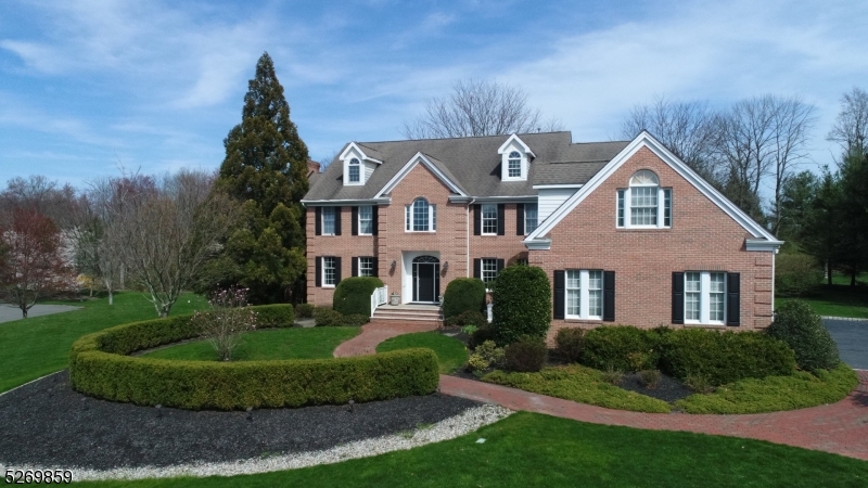 (Back on the market with a brand new deck and the pool is now open.) Nestled majestically in a neighborhood just outside of Princeton on a sprawling two-acre lot of meticulously manicured grounds, this stately colonial offers an unparalleled blend of timeless elegance inside with the allure of resort-style living outside. Step inside to discover a haven of sophistication, where tall ceilings and gleaming hardwood floors create an ambiance of refined grandeur. A first floor guest suite complete with a fireplace and private bath is at one end of the home while formal rooms, a vaulted great room, commercial grade kitchen with center island and breakfast room with sliders open to a deck, patio and pool. Double staircases, lead to fantastic bonus room, a primary suite with a sitting room and dual closets, three more bedrooms, one ensuite and hall bath. Lower level has play spaces, gym, sauna room, full bathroom, a second cozy family room and plenty of storage space. Stunning gardens surround the Anthony-Sylvan Gunite pool for outdoor gatherings with plantings by Kale's Nursery.  This property offers a full three levels of gracious living with versatile space for recreation, entertaining, or simply to unwind. Located just ten minutes from the University Town of Princeton, where one can enjoy convenient access to shopping, dining and theater amenities.