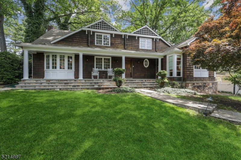Spacious and gorgeous expanded ranch set on private park like property in the heart of Short Hills. The spectacular eat in kitchen w/center island opens to an extraordinary family room with a custom built in and doors out to the yard and stunning brick patios.  The main level also has a phenomenal primary suite with 2 huge walk-in closets. Do not miss the sunroom off the formal LR that also brings outdoors inside. The formal DR also opens to the yard for entertaining. The second floor has 3 big bedrooms, one with an en suite bath, plus a hall bath. The basement is finished with a rec room and a half bath and has access to the garage.  Hardwood floors, huge windows, high ceilings all add the feeling of space and flow to this wonderful home, cared for so lovingly by its owners.