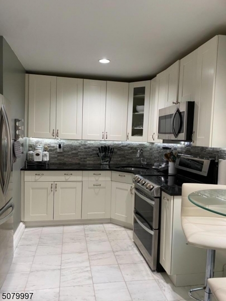 Immaculately maintained, UPGRADED unit in a great location with easy access to major highways and NYC bus in front of building. Gleaming hardwood floors, updated kitchen w/ shaker cabinets, large shower, crown molding, upgraded bathroom w/ real tile in floors and shower AND 2 (TWO!) closets in bedroom. Beautiful garden/sitting area outside of unit. Laundry and storage within steps! HOA incl. heat/water/sewer, ample parking and snow removal included. Tenant-occupied @ $1375/mon; tenant would like to stay through Feb 2022. - Hurry, won't last long!