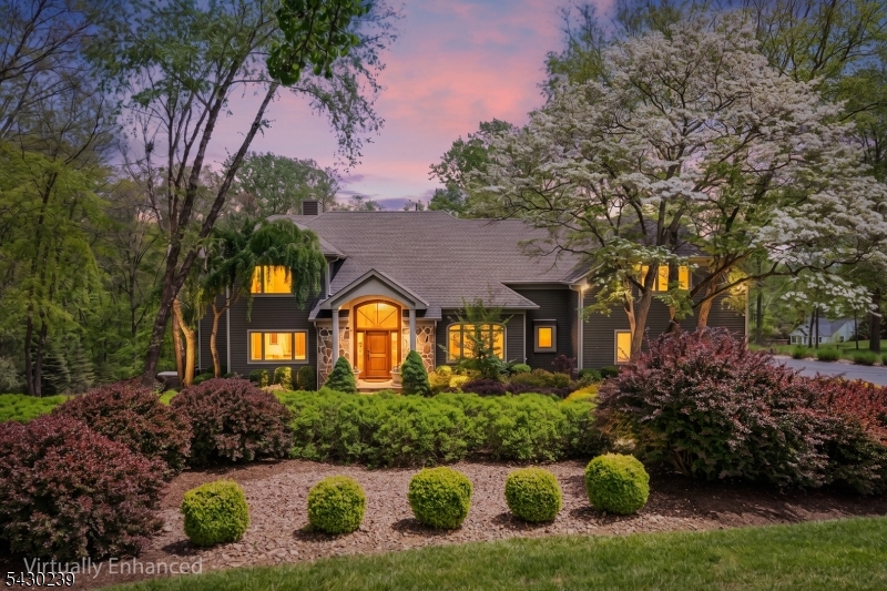 This exquisite Custom CH Colonial sits on a private, professionally landscaped 2-acre cul-de-sac lot, offering over 4,000 sq ft of living space plus a 2,000 sq ft unfinished w/o lower level. The 2022 renovated kitchen is the heart of the home, featuring Taj Mahal quartzite countertops, premium Thermador appliances, a coffee station, beverage center, and a wet bar with a wine cooler. It overlooks a grand great room and connects seamlessly to outdoor entertaining via three French/sliding doors that open to an expansive two-level IPE deck. The main level also includes a formal dining room, a living room/study, a sunroom with a double-sided fireplace, 2 powder rooms, & remodeled laundry room (2022) with chute. The upper level features a primary suite with spa-like comfort and 2 walk-in closets, plus 3 additional bedrooms, 2 updated bathrooms (2021), a media room, and dedicated storage. The resort-style backyard is an entertainer's dream, complete with the two-level IPE deck, a Colorado bluestone patio, Marquis hot tub, stone fire pit, and a tranquil koi pond with a waterfall. Recent updates include: new roof & gutters (2022), freshly painted exterior (2025), new second-floor HVAC (2026), new driveway (2026), whole-house generator, Sonos audio system, security cameras, central vacuum, and 13-zone irrigation. Located minutes from downtown Chester and served by top-rated Blue Ribbon Chester & Mendham schools, this property offers a perfect blend of luxury, comfort, and convenience.