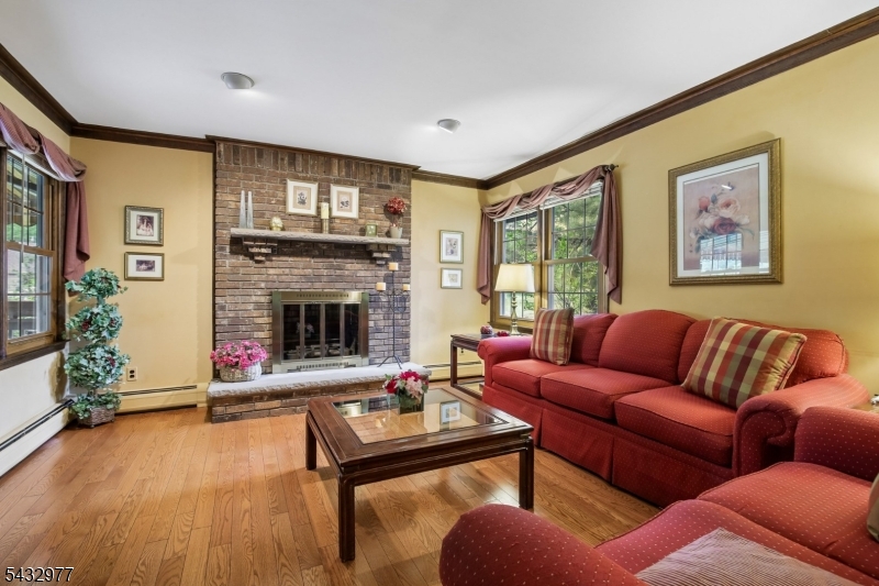 Impeccable Tudor Colonial in desirable Evergreen Estates! Set on a beautifully manicured private lot with a flat backyard, this spacious 4 bedroom, 2.1 bath home offers a classic floor plan ideal for both everyday living and entertaining. Features include hardwood floors, crown molding, formal dining room, bright living room, and an inviting family room with large brick fireplace. Updated kitchen with stainless steel appliances, gas range, granite countertops, and access to an expansive deck with canopy for shaded outdoor enjoyment. Convenient first-floor laundry and powder room. Second level offers 4 generously sized bedrooms, including a primary suite with walk-in closet and ensuite bath. Large unfinished basement provides endless possibilities for additional living space, home office, gym, or recreation area. These original owners have updated and maintained this home throughout the years to also include replacement windows, doors, all siding replaced including cedar shingles and large deck canopy.  This beauty is located on a fabulous cul-de-sac street in one of Wayne's most sought-after neighborhoods!!