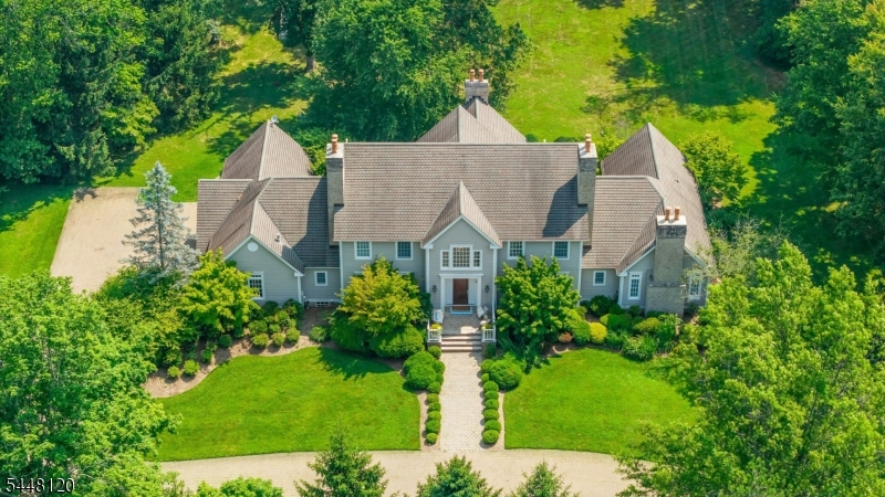 Situated in the heart of bucolic Harding Township horse country, this exceptional estate spans four level, usable acres offering space for privacy and recreation. A semi circular paver drive leads to the homes grand foyer, accented by a sweeping staircase. Designed with intentional and practical flow, the main floor features distinct formal living and dining spaces, a first floor study, eat in kitchen and vaulted family room alongside a substantial primary suite equipped with four walk-in closets and a sizable ensuite bath. The upper level provides four additional bedrooms arranged with Jack-and-Jill baths, as well as a dedicated walk-up staircase to a full-height attic. Below, a generous full-height basement provides versatile bonus living spaces. Complemented by a four-car garage, the property sits within 10 minutes of both Morristown and Madison train stations. Exceptional local access to the neighborhood library, public paths, tennis courts and Bayne park.