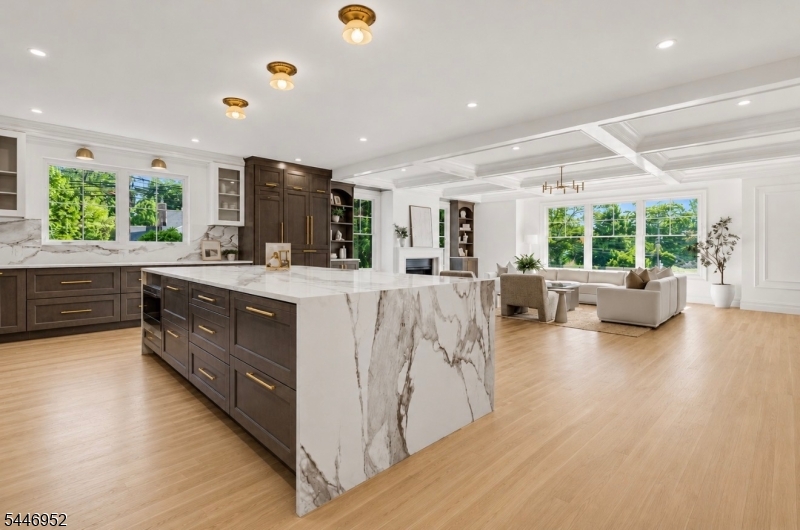 Introducing one of Madison's newest custom luxury estates, masterfully built by Champion Estates Developers, where timeless architecture meets sophisticated contemporary design. Spanning approximately 7,500 sqft across four spectacular levels. Featuring 7 bedrooms, each with its own private en-suite and custom closet, 7 full bathrooms, 1 half bath, and a bonus room ideal as a private office or optional 8th bedroom, this remarkable residence was designed for grand-scale entertaining and effortless everyday living. A private first-floor guest en-suite offers its own separate entrance. The chef's kitchen showcases premium Wolf appliances, a Thermador refrigerator, and a fully equipped scullery with a second refrigerator, second dishwasher, warming drawer, and generous prep space. A dramatic four-story stair tower is crowned by a stunning 32-foot designer chandelier. The luxurious primary suite features dual custom walk-in closets, a private coffee lounge, and a spa-inspired bath with heated floors throughout. The walkout lower level offers a private en-suite with its own walkout entrance, an expansive media room, and a private wellness studio with a sauna. Professionally landscaped grounds include a full exterior irrigation system. Just moments from downtown Madison, top-rated schools, boutique shopping, fine dining, and Midtown Direct service to NYC, this exceptional residence offers an extraordinary luxury lifestyle.