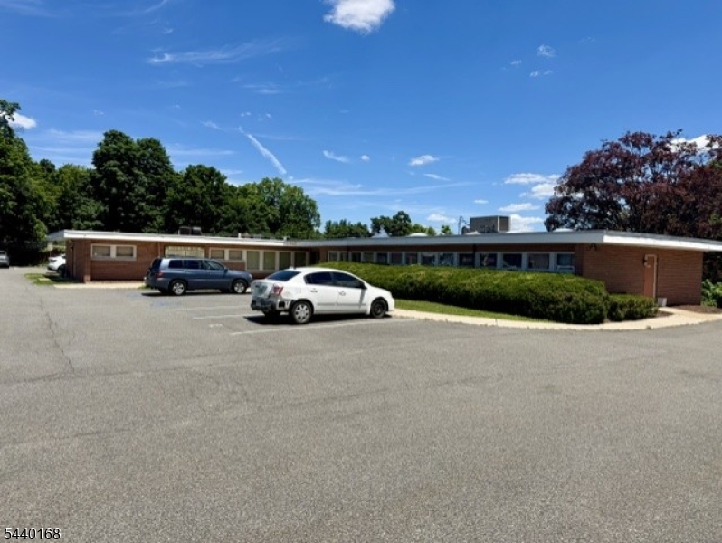 Professional office space drenched in natural light (currently being used as doctor's office) features 3 exam rooms, waiting room, receptionist area, 2 Bathrooms (private/patients) plus corner office! 2 separate entrances (public/private) at parking lot level for handicap accessibility. Additional space available for storage or kitchen (sink and cabinets already there). Conveniently located in Doctor's Park across from Dover Hospital. Ideal space for any profession! unit 1