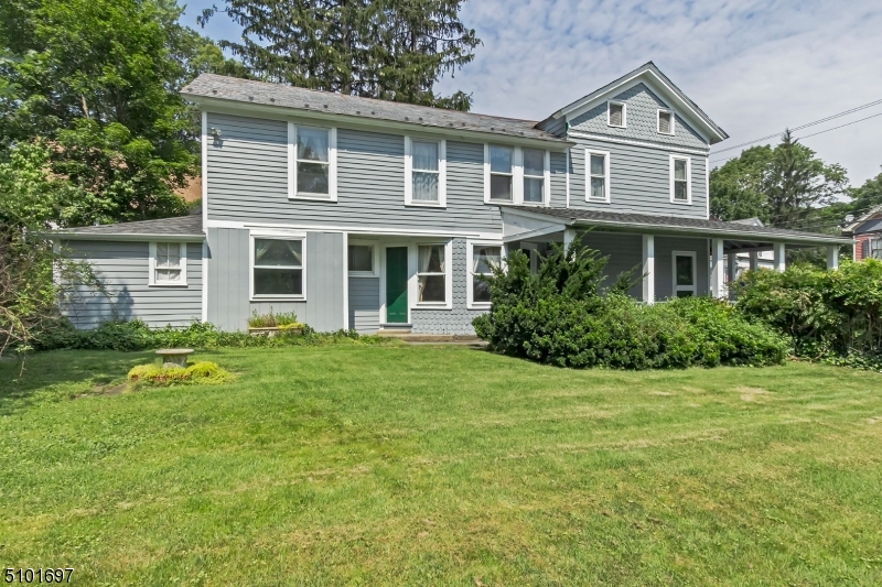 The craftsmanship of the era is evident in this historical home.  The spacious kitchen is adjacent to the dining room and light & bright living room with wide plank hardwood floors. The renovated baths and multiple bedrooms plus upstairs office with ample parking make this the perfect home for easy living.  The rocking chair wrap around porch looks out over larger park like property.  Brand new roof! This desirable, in town location, makes it ideal to stroll to the many restaurants, microbreweries, shops, mass transits and more... Truly a must see!