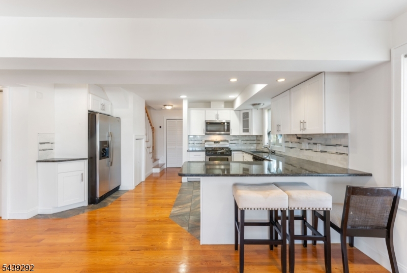Welcome to 307 E Elizabeth Avenue, Unit 5, a bright and spacious newer-construction condo ideally located just one block from the Linden Train Station and vibrant downtown Linden.Situated on the third floor, this well-maintained home offers an open and inviting layout filled with natural sunlight. The main level features a spacious living room that flows seamlessly into the modern kitchen, complete with a breakfast bar, ample cabinetry, and an open-concept design perfect for everyday living and entertaining. A convenient half bathroom and dedicated laundry room complete the first floor.Upstairs, you'll find two generously sized bedrooms, including a primary bedroom with a walk-in closet, along with a full bathroom and plenty of storage space. Storage closet on ground floor.  Enjoy the convenience of being moments from NJ Transit, shopping, dining, parks, and major highways, making commuting to NYC and surrounding areas a breeze. Whether you're a first-time buyer, downsizing, or looking for a low-maintenance lifestyle, this move-in-ready condo offers comfort, convenience, and an unbeatable location.