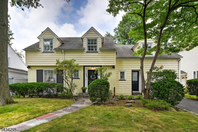 Located in highly desirable Putnam Manor, this thoughtfully maintained expanded Cape combines preserved craftmanship with an exceptional location. Set on a quiet tree-lined street just one block from NYC bus service and minutes from the GSP, RT22, RT78 & NJTPK, this home offers the perfect balance of peaceful living and commuter convenience. A spacious entry foyer welcomes you into the home with hardwood floors and molding throughout. The living room is centered around a classic wood-burning fireplace that flows into a formal dining room with built-in cabinetry, chandelier and an adjoining den overlooking the backyard. Eat-in kitchen features an attached half bath and a separate entrance for easy outdoor access.Upstairs, the second level is anchored by a spacious central landing with classic woodwork, a bright window nook and extra closest space. Three generously sized bedrooms offer dormered ceilings and abundant natural light. The primary bedroom features an adjoining sitting room creating flexible space for lounging or home office. The full bath with preserved vintage tile offers immediate opportunity to make it your own.A clean, bright, and maintained basement expands the home's living space with built-in shelving, cabinetry, and plenty of storage. Outside, mature landscaping, attached garage, and fenced backyard offer immediate opportunities for entertaining, gardening, or relaxing.Enjoy timeless charm, convenience, & room to grow with this classic home in Putnam Manor