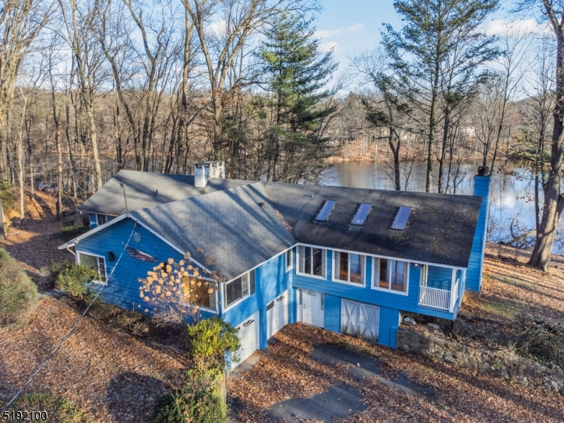 This land is being sold with Block 18 Lot 4. Address 4 Lake Lenore Rd. with lovely lakefront home technically in Parsippany with Denville mailing address. Additional 2.789 Ac. Approx 4.5 Acres combined. Parsippany taxes are approximately $14,755. Welcome to your very own Shangri-La lakefront on Lake Lenore in desirable Denville/Parsippany! Situated on over 4.5 premium acres, with a Koi pond, outdoor fireplace, deck, dock, patios, and pure solace. With a vision and sweat equity you can bring this 3 bedroom, 2.5 bath Ranch home into winning competition to the million dollar homes in the area. None will have the land and lakefront like you! This home offers large bedrooms, Master bedroom w/full Master bath, amazing Great Room with wall to wall brick fireplace, walls of windows , sliders to deck, skylights, wood flooring and open concept to the kitchen and eating area! Formal Dining room, Living room with wood burning fireplace and main bath finish this level . The finished basement (approx. 2000 sq.ft.) w/separate entrance, brick fireplace, full wet bar, laundry room, sliders to patio, large windows with lots of natural light and access to attached garage. Add a circular driveway, detached 2 car garage, outdoor shed, city water/sewer. Estate sale, strictly as is.