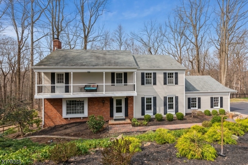 Stylish serenity in a private setting! Spacious and modern Colonial situated on a landscaped lot at the end of a quiet cul-de-sac in one of the most sough-after neighborhoods in Morris Twp. This home is just minutes away to a lively downtown with to shops, restaurants, MPAC, Routes 287, 202 and Midtown direct Train to New York City.  With gorgeous hardwood floors, chair and crown moldings, large windows letting in lots of natural light and an updated kitchen, this beautiful home is ideal for entertainment in style. Welcoming spacious foyer invites you to a large living room with a brick suround wood burning fireplace and an adjacent formal dining room. The updated eat-in kitchen features Quartz counters and backsplash, SS appliances, pantry, bright cabinetry with a large center island with seating. Off the kitchen is a convenient first floor office with a custom built floor-to-ceiling shelving and the laundry room with access to the deck overlooking the private backyard and woods beyond. The second floor includes a spacious primary suite, updated en suite bathroom, walk-in closet, and dressing area.  Three large additional bedrooms, one with a charming balcony, and an updated hall bathroom. The fully finished walkout basement to backyard patio offers a fantastic space for entertaining with a wet bar, powder room, workshop and plenty of storage. This distinctive home offers a harmonious balance of a tranquil .77 acre property backing to Township parkland.