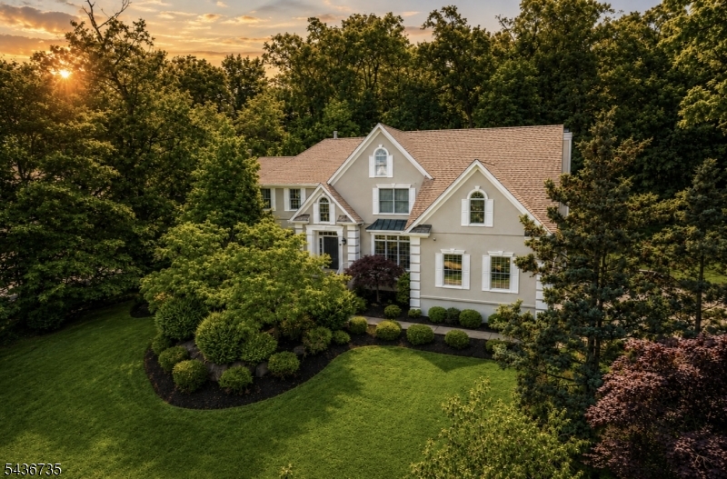 Welcome to 66 Beachmont Terrace! This stately 5 bed, 5.5 bath center hall colonial is situated in one of North Caldwell's most sought-after neighborhoods and truly offers the BEST of luxury living. As you enter the foyer, you are greeted by soaring cathedral ceilings that set the tone for the grandeur that awaits. To your left, discover the oversized yet cozy living room appointed with the first of three fireplaces. To your right, you will find the elegant dining room with subtle woodwork detail, perfect for hosting more formal dinners and holidays. The dining room and kitchen are thoughtfully connected by a butler's pantry.  As you continue towards the back of the house, the bright eat in kitchen flows directly to the spacious family room. Step outside to the oversized deck to enjoy effortless alfresco dining. The deck leads down to a lush and private yard surrounded by woods--perfect for playing and entertaining.  The first floor also boasts a 5th bedroom/office with its own bath. Upstairs you will find four additional generously sized bedrooms with ensuite baths. The primary suite and 4th bedroom both offer their own private sitting rooms which provide additional space to work or unwind. The full finished basement is equipped with a home gym and playroom, as well as a full bath with sauna. 66 Beachmont seamlessly blends timeless charm with modern amenities offering a lifestyle of both sophistication and comfort.