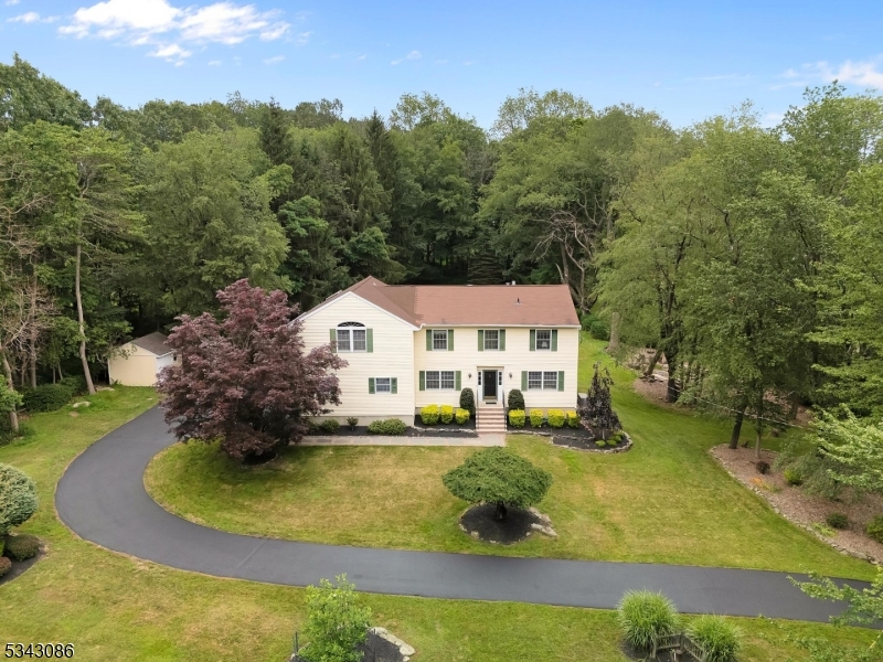 Welcome to this beautifully updated Colonial, a perfect blend of classic elegance and modern convenience, nestled on beautiful, level and usable 3+ acre lot. This home features an automatic gas generator, ensuring peace of mind during power outages. Step inside to discover a spacious formal living room bathed in natural light, perfect for entertaining guests. The dining room boasts built-in cabinets and a striking granite countertop, ideal for hosting dinner parties. The heart of the home is the kitchen, featuring hardwood floors and ample storage space, making meal preparation a delight. Adjacent to the kitchen, you'll find convenient access to the 2 car garage through the laundry room/mudroom, keeping everything organized. The main floor also includes an updated powder room and a cozy family room with a gas fireplace and built-ins, providing a warm and inviting atmosphere. Upstairs you'll find four spacious bedrooms, offering plenty of room for guests. The three full, updated bathrooms provide modern amenities and comfort. The partially finished basement features a recreational room, perfect for gatherings or a play area. Enjoy the low-maintenance exterior with durable vinyl siding and energy-efficient thermal pane windows. Stay comfortable year-round with baseboard hot water heat and central air conditioning. The large, level lot includes a shed for extra storage. Don't miss the chance to make this exceptional home yours!