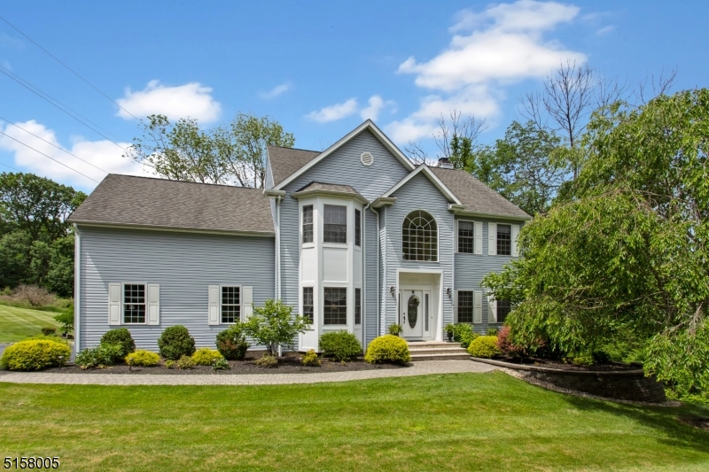 Located in Long Valley Section of Morris County's Washington Township Stately Colonial impeccably cared by original owners built in 2000. Gracefully designed and decorated. This 4 bedroom 2 and 1/2 bath home has it all.  There is a formal dining room to the left of the 2 story light filled foyer with custom windows. A formal living room is on the right.  Down the main hall of this Center Hall Colonial is a large open family room w/wood burning fplc .  Adjacent to the family room is a stunning new kitchen with all high end appliances and cabinetry completed in  2021.  An entertainers dream to cook for guests in the kitchen or barbecue on the deck just through the sliding glass doors. Also on the 1st level is a laundry room and powder room. Upstairs you cannot believe the size of the Primary bedroom The Primary bath is extra large  with a stall shower and separate soaking tub.  There is a sitting room in the Primary suite & 2 walk in closets! 3 additional  beds & a full bath complete the 2nd floor.  We are not done!  There is a finished basement with an office, gym, sitting room & rec room with a gas fireplace.  Sliders to the back yard make this a fine area to entertain inside or outside. The parklike grounds are beautifully landscaped &  showcase a deck, paver patio, fire pit, hot tub & pond.  Vacation at home on almost 2 acres with all the amenities of a resort!   Are you still home?   Get in your car & see this home so close to major highways yet serene and private setting