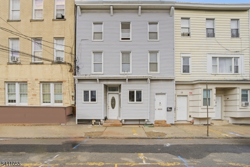 Legal 3-family investment opportunity just blocks from the 8th Street Light Rail, offering strong upside in one of Bayonne's fastest-evolving pockets. This property features a total of 7 bedrooms and 3 full bathrooms across three units, making it ideal for investors, owner-occupants, or those looking to maximize rental income. Each unit offers spacious layouts with great natural light, hardwood flooring, and functional living space. Select updates include refreshed interiors and an updated kitchen with modern cabinetry, countertops, and tile backsplash. Separate entrances and a classic multi-family layout provide flexibility for leasing and long-term hold strategies. The property also includes a private backyard, adding value for tenants and enhancing overall appeal. Positioned near the 8th Street Light Rail for easy access to Jersey City and NYC, the location is further strengthened by the nearby development of 1888 Studios, a major film production campus expected to bring significant job growth, infrastructure investment, and increased housing demand to the area. While the property requires some TLC, it is priced accordingly and presents a compelling value-add opportunity with strong long-term potential.Buyer responsible for all inspections and municipal requirements, including C/O. Property sold strictly as-is.
