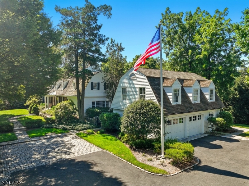 "OLD STONE COTTAGE" * A MAGNIFICENT SHORT HILLS ESTATE * Set atop 1.5 acres of landscaped grounds, this home offers timeless character, modern amenities, and exceptional spaces for living and entertaining. The welcoming entry hall with elegant staircase opens to a sun-filled LR w/ fireplace, adjoining marble sunroom and music room. Formal DR w/ fireplace & butler's pantry/wet bar is ideal for gatherings. Gourmet kitchen features custom cabinetry, 6-burner Wolf range, 2 SubZero's, dual dishwashers, marble/wood center island, farmhouse sink, walk-in pantry & breakfast room. Private 1st-flr office, deluxe mudroom & show-stopping family rm w/ soaring beamed ceilings complete this level. Upstairs, luxurious primary suite offers a sitting room/office, marble bath w/ glass shower & oversized walk-in closet. Three more BRs, two more renovated baths & a sunlit sleeping porch. Off the mudroom, via private staircase, find separate guest quarters w/ workout room & bedroom, each with ensuite baths & kitchenette w/ laundry hookup. LL: billiards rm w/ wine cellar, rec rm, craft rm & full bath. Outside, find an oversized Bluestone patio, stone walls, fire pit, expansive lawns & over 75 peony plants -- inspired by original homeowners garden -- offer blooms for months in spring. Conveniently near South Mountain Reservation, Train Station, niche shops, dining & NYC. A private retreat in the midst of world class amenities & top-tier schools (Deerfield) - nothing short of perfection!