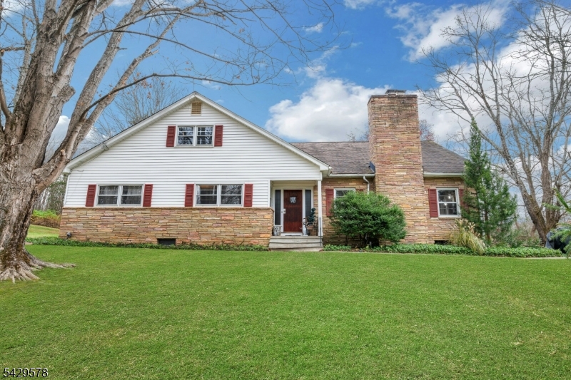 Beautifully maintained expanded ranch offering easy one-level living on a private, park-like property just a half mile to town center, school, shops, and community events. Sun-filled living room with brick fireplace, wood mantle, and custom built-ins. Newly refinished hardwood floors in LR, DR, foyer, and all bedrooms. Spacious EIK with stainless steel appliances, breakfast nook, built-in spice cabinet, pantry/broom closet, abundant cabinetry, and generous counter space. Heated 4-season sunroom with new vinyl flooring overlooks the yard. Two of the 3  bedrooms  feature double cedar closets & beautiful hardwood floors. The primary bedroom has a triple wide cedar closet and offers Jack-and-Jill bath access. Walk-up semi-finished attic provides flexible space for possible 4th bedroom, office, or family room. Expansive unfinished walkout basement, 2-car garage, and parking for 6+ cars. Recent updates include new windows (EIK, LR, DR, walk-up attic), updated electrical outlets, new electric panel for well system, and UV water remediation system. Oil tank professionally removed; permit closed with no leaks. All work completed by licensed contractors.