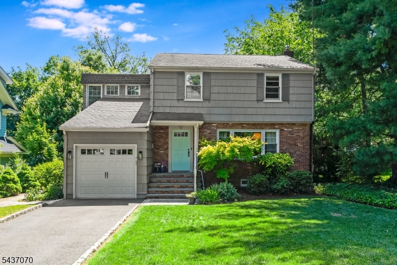 Perfectly positioned just blocks from vibrant downtown Maplewood, this beautifully updated home blends timeless charm with modern comfort. Sun-filled and inviting, the first floor features hardwood floors, a spacious living room with oversized windows, seamless flow to the dining room and eat-in kitchen, and a charming sunroom with new slider doors that offers additional living space and easy access to the backyard and large deck. The kitchen is both stylish and functional, featuring soapstone countertops, ample cabinetry, and a large window overlooking the private backyard. A first-floor bedroom, currently used as a cozy TV room with built-in bookshelves, and a full bath provide exceptional flexibility for today's lifestyle. Upstairs, four generously sized bedrooms feature double exposures, custom closets, and abundant natural light. The oversized primary bedroom features skylights, a large walk-in closet, and excellent storage. A generous hall bath includes a double vanity, beautifully tiled tub/shower, and a Toto Washlet bidet toilet. The finished basement provides versatile space for recreation, entertaining, fitness, or relaxation. Additional features include Pella wood windows throughout, central heat and cooling, an attached garage, updated outdoor lighting, and a thoughtfully designed pollinator garden filled with native plantings. Don't miss this exceptional home, where classic Maplewood character meets modern convenience.