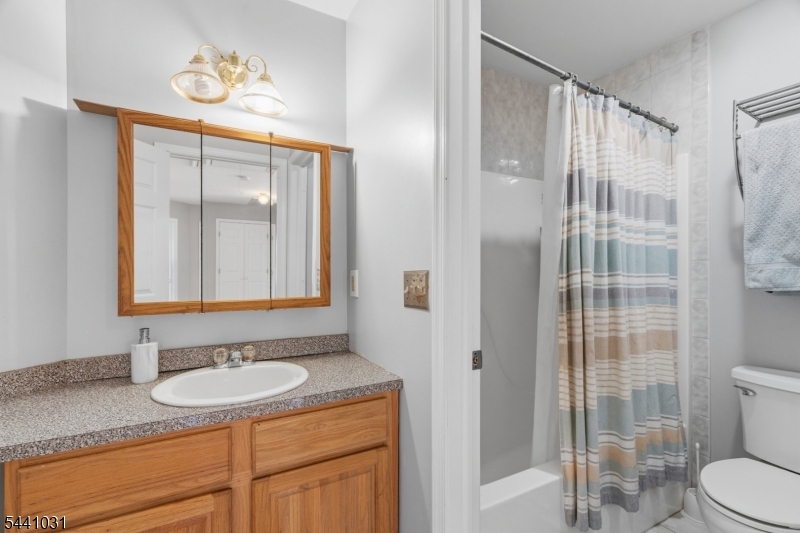Welcome to this impeccably maintained center hall colonial which is ideally situated on a private cul-de-sac in a highly sought-after neighborhood. The interior features a dramatic two-story foyer, formal dining room, and generously sized bedrooms throughout. The gourmet kitchen is equipped with a breakfast area, tile flooring, stainless steel sink, wood cabinets, new dishwasher, and built-in microwave. Additional highlights include gleaming hardwood floors, paddle fans in most rooms, elegant arched doorways, 9-foot ceilings, and a gas brick fireplace, recessed lights and tiled floor in the sun-drenched family room. Comfort is ensured with multi-zone gas hot water baseboard heating, along with newer furnace and newer hot water heater. The luxurious primary suite features a gorgeous bathroom including a soaking tub, stall shower, dual sinks, and a walk-in closet. Recent upgrades include a beautifully finished walk-out basement offering a spacious recreation, media, exercise or bar area, recessed lighting, laminate flooring and a private office, den or card room perfect for work or play. Step outside to enjoy the in-ground heated pool, expansive patio,  over 1/3 acre of level property and fenced pool area-  ideal for entertaining. This exceptional home offers space, style, and modern updates this home has it all!