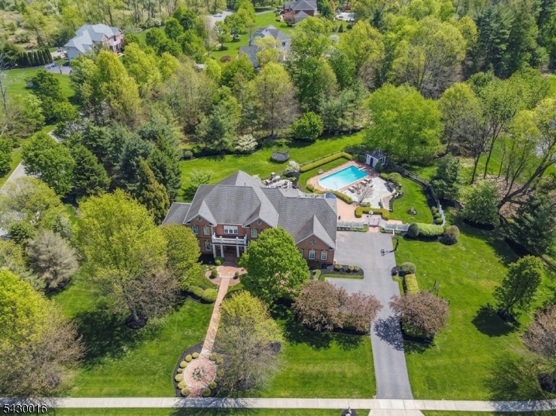 Welcome to this stunning colonial located in the highly desirable neighborhood of The Glen, perfectly positioned on a quiet cul-de-sac and filled with exceptional recent improvements throughout. This beautifully remodeled home offers luxury living, incredible entertaining spaces, and a tranquil private setting.  6,071 finished sq ft over 3 floors. The resort-style backyard is spectacular featuring gorgeous professional landscaping, a sparkling swimming pool, expansive bluestone patio, covered porch with rich Ipe flooring, stone fireplace, fenced yard, landscape lighting, and plenty of grassy area for play and recreation. The outdoor spaces create the perfect setting for entertaining or relaxing in complete privacy.  Inside, the home has been thoughtfully renovated from top to bottom with high-end finishes throughout. The spectacular NEW gourmet kitchen features marble tops, Wolf/Sub-Zero appliances, dual stoves, wine refrigerator, butler's pantry, and walk-in pantry. The kitchen flows beautifully into the dramatic great room with soaring cathedral ceilings and stunning stone fireplace. Additional main level highlights include a spacious conservatory and private home office.  The luxurious primary suite offers a spa-inspired bathroom, walk-in closet, and private balcony overlooking the serene property. Large guest bedrooms with beautifully remodeled bathrooms.  The finished walkout lower level includes a rec room, media room, exercise room, home office, and impressive wet bar.