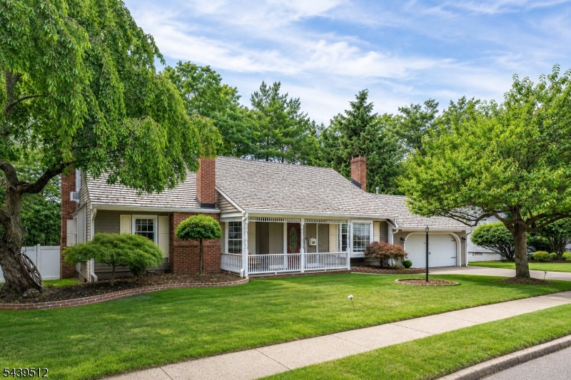 Welcome to this exceptional raised ranch offering an impeccable layout & the perfect blend of comfort, privacy, & functionality in one of Bergen Countys best. A grand center hall staircase connects three expansive levels, totaling about 3,300 sqft including the finished lower level. Featuring 4.5 bathrooms, each bedroom includes its own private en-suite bath, while the first-floor primary suite offers the convenience of one-floor living with a full bath & main-floor laundry. The recently renovated chef's kitchen serves as the heart of the home, sparing no expenses - featuring a large center island, abundant cabinetry, top appliances, large pantry, & seamless flow into the living/ dining areas. Four fireplaces add warmth & character throughout the home's gathering spaces. The impressive lower level offers endless possibilities as a bonus great room, entertainment area, or extended living space, complete with custom windows for maximum sunlight, a fixed bar with fridge, full bathroom, & second laundry area. Outdoor living shines with a welcoming front porch & a private backyard oasis featuring an oversized pond with a waterfall, expansive patio, & lush wooded surroundings. Features also include a two-car garage & two separate double-width driveways, one with direct access to Soldier Hill Road, offering unmatched convenience/ parking & room for recreational vehicles + a nearby golf course. Located near top-rated schools, NYC transportation, shopping, dining, parks, & much more.