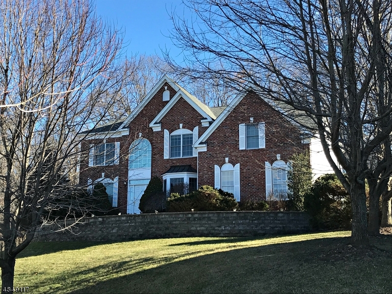 No second look needed! This impressive turn-key brick front 4BR/3.1BA colonial on a cul de sac in Wyndham Pointe boasts 4000+sf of living space, neutral color scheme throughout including recently painted bathrooms; wood floors throughout the 1st floor; high ceilings; crown molding, tray ceiling, home office with built-ins; spacious kitchen with granite, newer appliances and center island with breakfast bar; a true Master suite with double door entry, sitting area and enormous master bath and walk in closet. 2nd flr hall bridge overlooks 2-story foyer & family room;   Full unfinished basement with poured concrete foundation.  Private, treelined backyard backs to parkland and features a beautiful paver stone patio. Coveted location for its accessibility to major commuter routes, Turkey Brook park, schools.