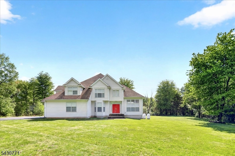 Set back from the road and surrounded by mature trees, this impeccably maintained custom-built energy-efficient home on nearly 9 acres offers privacy, comfort, and timeless design. The main level features a study with French doors, spacious front-to-back living and dining rooms filled with natural light, and a beautifully appointed kitchen with stainless steel appliances that opens to the family room with a gas fireplace and access to the rear yard and patio. A versatile main-level bedroom with California Closets and private exterior entrance offers flexibility for guests or a home office. A mudroom/laundry room and powder room complete the first floor. Upstairs, the spacious primary suite features its own fireplace, sitting area, oversized California walk-in closet with potential for conversion to an additional room, and a luxurious en suite bath with soaking tub, oversized shower, and double vanity. Two additional bedrooms share a convenient Jack-and-Jill bath. The extra-high walk-out basement offers endless potential for future finishing, recreation, storage, fitness, or hobby space. Additional highlights include a whole-house generator and new septic system to be installed. Conveniently located near Lambertville, New Hope, Pennington, Princeton, shopping, dining, train stations, and Routes 202, 295, 1, and 95, this exceptional property offers peaceful country living with easy commuter access.