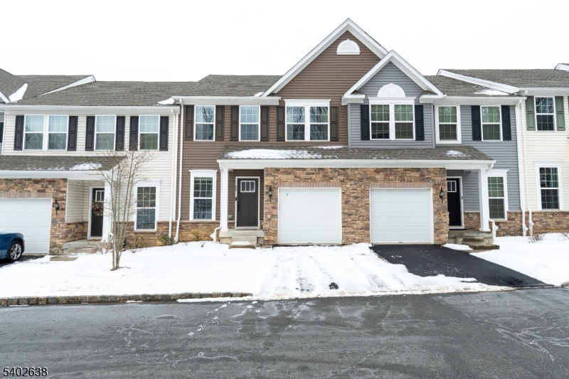 Set within the quiet and welcoming Shadow Woods community, this move-in-ready interior townhome offers a comfortable, low-maintenance lifestyle in a peaceful setting. The main level is thoughtfully laid out for both everyday living and entertaining, featuring a spacious living room, an adjacent dining area, and a kitchen with a center island that naturally becomes the gathering spot. Upstairs, the primary bedroom serves as a private retreat with its own en-suite bath. Two additional bedrooms and a full hall bath provide flexibility for guests, home office space, or additional living needs. Laundry is also located on the 2nd flr.  The finished basement expands your options even further, offering versatile bonus space ideal for a family room, fitness area, or hobby space.  Step outside onto the deck and enjoy the tranquil backdrop of mature trees that frame the community a perfect spot to unwind or enjoy the outdoors. Shadow Woods residents benefit from maintenance services that include snow removal, exterior upkeep, and trash collection, making day-to-day living refreshingly simple. Conveniently near Route 80 and approximately one mile from the Mount Arlington NJ Transit station, commuting is easy. For recreation, Lake Hopatcong and nearby parks are just minutes away, offering opportunities for boating, hiking, and enjoying the outdoors year-round.