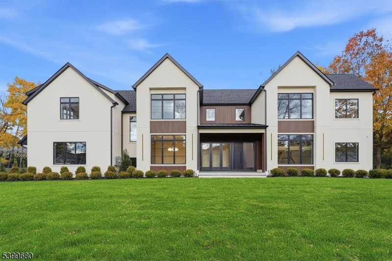 Another stunning custom home by renowned Fermano Builders, perfectly situated on Demarests prestigious east side, offering over 7,200 sq ft of meticulously crafted luxury living on .55 acre. Designed by award-winning FDS Architects, this home features a dramatic two-story foyer w/ a floating glass-enclosed staircase leading into a breathtaking double-height family room w/ a striking stone-and-wood clad fireplace. A sophisticated glass wine display elegantly connects to the formal dining room. The gourmet kitchen is a chefs dream, boasting top-of-the-line stainless steel appliances, double islands, a walk-in pantry, a sun-drenched breakfast room, and a stylish wet bar just off the kitchen, perfect for entertaining. The first floor is enhanced by 10-foot ceilings and includes a refined office/library, a sumptuous ensuite bedroom/cabana, and two beautifully appointed powder rooms. Upstairs, the oversized primary suite features a serene sitting area, two expansive walk-in closets, and a spa-like bath w/ soaking tub and oversized shower, and complemented by three additional ensuite bedrooms and a convenient laundry room. The fully finished lower level provides a complete entertainment haven w/ a rec room, deluxe media room, gym, versatile ensuite bedroom, game room, and sleek wet bar. Additional highlights include a three-car garage, a covered patio, and room for a pool. This rare residence blends modern luxury, sophisticated design, and an unrivaled Demarest location.