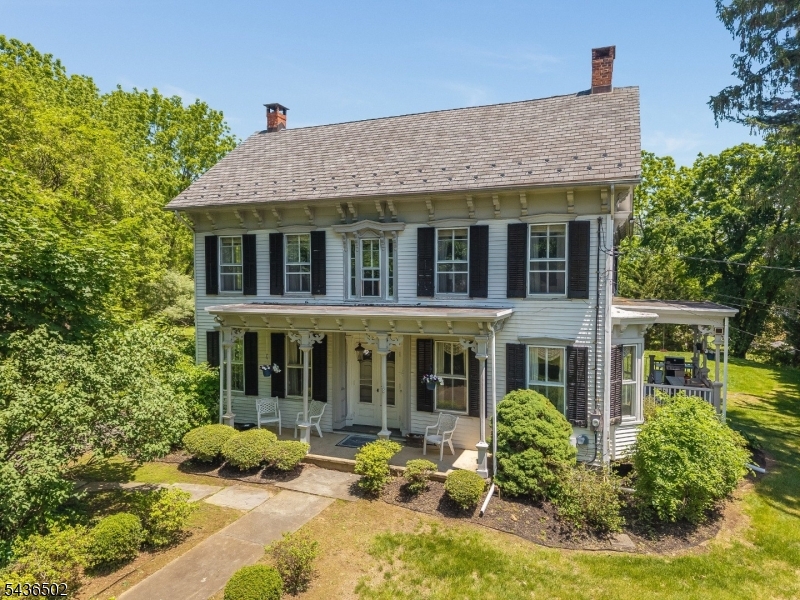 WELCOME HOME TO TIMELESS ELEGANCE AND OLD-WORLD CHARM!  CIRCA 1850, THIS CAPTIVATING 4 BEDROOM, 3 FULL BATH COLONIAL IS NESTLED ON 1 ACRE OF BEAUTIFUL PARK-LIKE GROUNDS AND FEATURES AN IMPRESSIVE OVERSIZED BARN THAT ADDS TREMENDOUS CHARACTER, CHARM, AND ENDLESS POSSIBILITIES FOR STORAGE, HOBBIES, OR WORKSHOP SPACE.   BLENDING HISTORIC CHARACTER WITH MODERN UPDATES THROUGHOUT, THIS HOME IS TRULY ONE OF A KIND! THE HEART OF THE HOME IS THE STUNNING EAT-IN KITCHEN FEATURING STAINLESS STEEL APPLIANCES, GRANITE COUNTERTOPS, A CENTER ISLAND, AND A COZY FIREPLACE. THE ADJOINING FORMAL DINING ROOM OFFERS ACCESS TO A SPACIOUS DECK, PERFECT FOR ENTERTAINING.THE FORMAL LIVING ROOM BOASTS ANOTHER FIREPLACE, ACCESS TO A SECOND DECK, AND IS FILLED WITH WARMTH AND CHARM.  A CONVENIENT FIRST-FLOOR LAUNDRY ROOM ADDS TO THE HOME'S FUNCTIONALITY. ENJOY 10-FOOT HIGH CEILINGS AND BEAUTIFUL HARDWOOD FLOORS THROUGHOUT THE FIRST FLOOR.  UPSTAIRS, THE SECOND LEVEL FEATURES GORGEOUS PUMPKIN PINE FLOORS, A PRIVATE OFFICE, AND ACCESS TO THE THIRD LEVEL. THE PRIMARY SUITE OFFERS A FULL BATH, WHILE THREE ADDITIONAL BEAUTIFULLY APPOINTED BEDROOMS ARE SEPARATED BY A HALLWAY AND FULL BATH FOR ADDED PRIVACY.  FIREPLACES ARE IN AS-IS CONDITION.   ENJOY THE PERFECT COMBINATION OF HISTORIC CHARM, MODERN COMFORTS, AND A PRIME LOCATION CLOSE TO SCHOOLS, SHOPPING, AND RESTAURANTS.  A RARE OPPORTUNITY TO OWN A PIECE OF HISTORY WITH ALL THE CONVENIENCES OF TODAY!