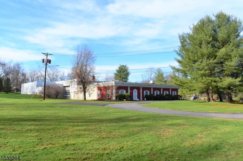 Spectacular mixed use property with commercial in front and residential in rear. Property includes 11.273 acres with a 1 story brick building with 1,200 sq. ft. of office space with kitchen area.   There is a large door in the rear of the building that can be used for a loading dock. Ceiling in the main part of building is 18-20 ft. high, 800 amp of electric from former machine shop. 2 ton overhead crane. Central air and heat, garage has ceiling heat unit. The property includes a rental property 2 B/R, 1 bath, fireplace, basement and updated kitchen. Home has separate HVAC