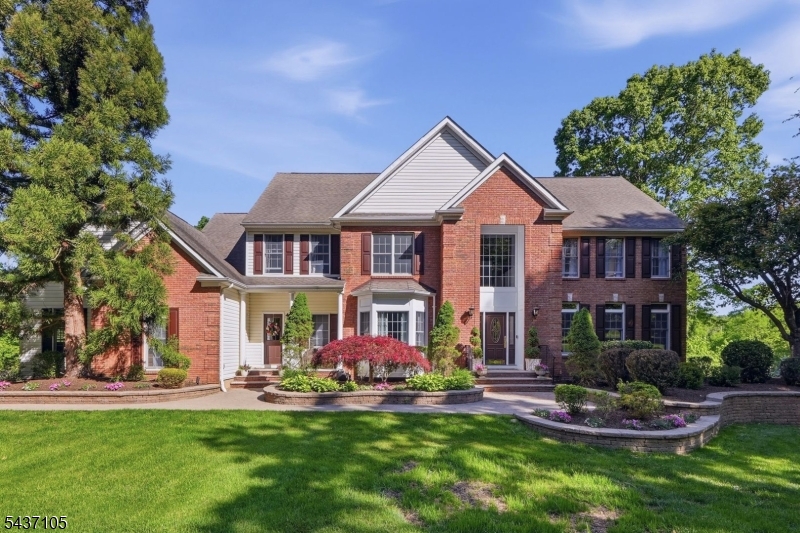 First time ever offered for sale, this immaculate brick-front Center Hall Colonial is nestled on a breathtaking 2-acre property in one of Chester's most sought-after locations. A picturesque tree-lined driveway welcomes you to this private retreat surrounded by mature landscaping, lush greenery, and exceptional curb appeal. The inviting floor plan features an elegant formal dining room, a sun-filled sitting room, and an updated white eat-in kitchen with premium Wolf stainless steel appliances, a large center island, abundant cabinetry, and generous storage. The kitchen flows seamlessly into the spectacular family room featuring soaring vaulted ceilings, a striking fireplace, and custom windows overlooking the scenic grounds. A 1st-floor flex room, full bath, PR, laundry room, secondary entrance & 3 car garage complete the main level.  Upstairs, the luxurious primary suite offers dual walk-in closets and a spa-inspired bath with a soaking tub and separate stall shower. Three additional spacious bedrooms, a full bath, and an oversized bonus room provide flexibility for today's lifestyle. The newly finished walkout lower level expands the living space with a recreation room, full bath, exercise room, additional bedroom, and more storage. Relax or entertain on the expansive deck overlooking the private backyard. Combining timeless elegance, modern updates & a serene Chester setting, this meticulously maintained home presents a rare opportunity to own a truly exceptional property.