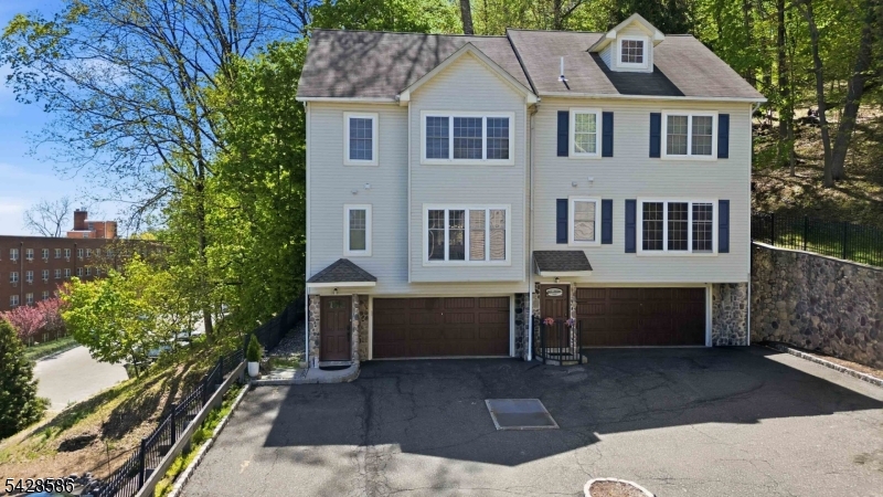 A rare opportunity in one of Morristown's most private and unique townhome enclaves, just 9 homes tucked beside the protected green space of Morristown National Historical Park/Fort Nonsense, yet only .35 miles from Downtown Morristown. This beautifully renovated townhome offers the convenience of in-town living without the typical in-town price tag, plus features hard to find so close to the Green: an oversized two-car garage, a private patio, generous natural light, and a quiet setting with excellent privacy.  Renovated in 2021, the home has been tastefully updated with a new kitchen and baths, hardwood floors, neutral tones, and a sophisticated, move-in-ready style.  Stainless steel appliances in the kitchen, and lots of storage space. The open, multi-level floor plan provides comfortable living and entertaining space, with hardwood floors, spacious bedrooms, excellent closet space, gas cooking, and a bright dining area with sliders to the private outdoor space.  Laundry is conveniently located on the second floor, right outside the bedrooms. With no overlapping living space from neighboring units, the layout feels more private and substantial than many townhouse options.  Rarely available and ideally located near Downtown Morristown, the Morristown Green, restaurants, shops, parks, and NYC Midtown Direct train service this is an exceptional alternative to Morristown's higher-priced in-town homes and townhomes. One not to be missed.