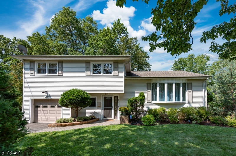 Beautiful split-level with great curb-appeal, nestled in quiet tree-lined neighborhood on Livingston border.  This bright property is a sun-lover's dream with its open floor plan and generous windows. The walls are freshly painted with neutral colors and is move in ready. Stunning cherry floors seamlessly compliment the cherry cabinets and stainless steel appliances. Feel safe & secure with the Generac whole-house automatic generator. Plenty of room to relax and entertain with a large deck & spacious flat backyard. Enjoy the lush greenery with well-kept landscaping throughout. Home is just blocks to NYC commuter bus, Rt280, great shopping on Rt10, supermarkets and farmer's market, wonderful parks and trails, Turtleback Zoo, golf courses & houses of worship. You will want to make this house your home!