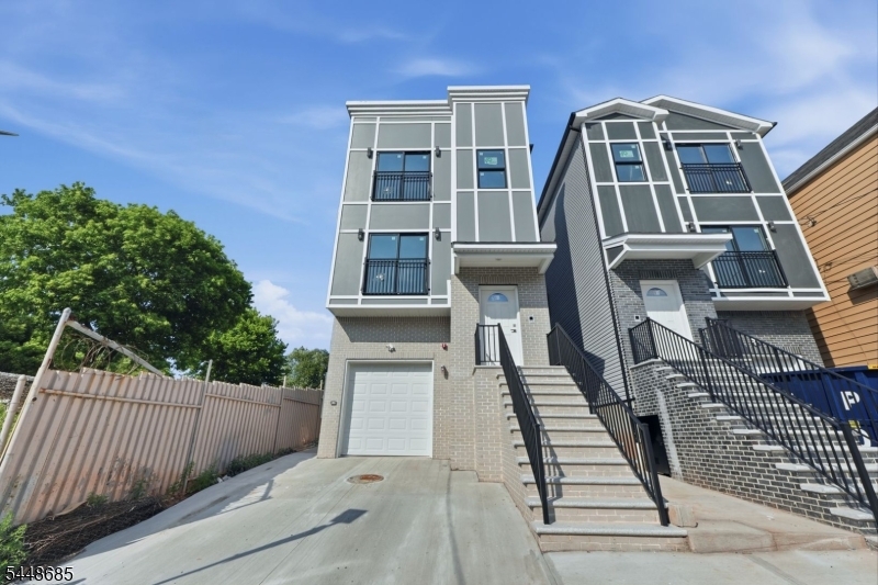 Stunning newly constructed two-family home featuring a finished walkout ground level with a full bathroom, offering valuable additional living space. An excellent opportunity for both investors and owner-occupants seeking long-term value and potential rental income. Quality craftsmanship and modern finishes are showcased throughout. Both the first- and second-floor units feature 3 bedrooms, 2 full bathrooms, an open-concept living and dining area, a beautifully designed kitchen with a peninsula offering seating, brand-new stainless steel appliances, and an in-unit laundry room. The first-floor unit is designed in a duplex-style layout with direct access to the finished walkout ground level, which includes a spacious family room, a full bathroom, and access to the backyard and attached garage. Both primary bedrooms feature private en-suite bathrooms. Additional highlights include two separate HVAC systems with central air, an oversized attached garage, and a private backyard ideal for relaxing or entertaining. Conveniently located near NYC transportation, schools, shopping, restaurants, and major highways. The property includes a 5-year tax abatement and is backed by a 10-year home warranty.