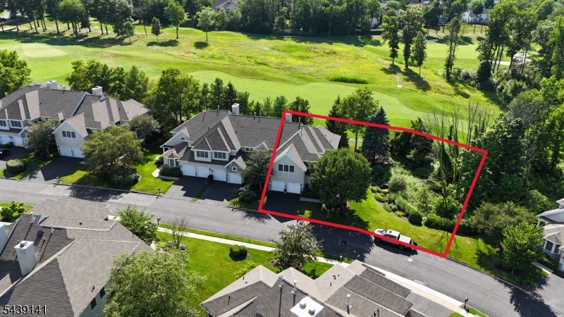 Golf Course Living on the 12th Fairway! Discover luxury living in this beautifully maintained 3-bedroom townhome in prestigious Amherst Mews with breathtaking views overlooking the 12th fairway of NJ National Golf Club. Designed with an open floor plan ideal for entertaining, the main level features formal living and dining rooms plus a spacious family room with gas fireplace, custom built-ins, and wet bar flowing into the kitchen with center island, abundant cabinetry, generous prep space, and breakfast area. A second-floor bonus room with custom built-ins, bookshelves, file cabinets, and media workspace is perfect for a home office or flex space. The primary suite offers two large walk-in closets and a spa-like bath with double vanity, soaking tub, separate shower, and makeup vanity. Two additional spacious bedrooms and full bath complete the upper level. The finished basement is an entertainer's dream with custom wine cellar, built-in bar, and flexible recreation space. Relax on the private stone patio with a 20-foot dry-stone wall and spectacular golf course views. Recent updates include new EIFS siding, lower-level HVAC, hot water heater, and roof. Residents enjoy resort-style amenities including a clubhouse, pool, tennis courts, fitness center, and beautifully maintained grounds. Located in a top-rated school district with convenient access to transportation, shopping, and dining, this exceptional golf course townhome offers luxury, comfort, and an unbeatable location.