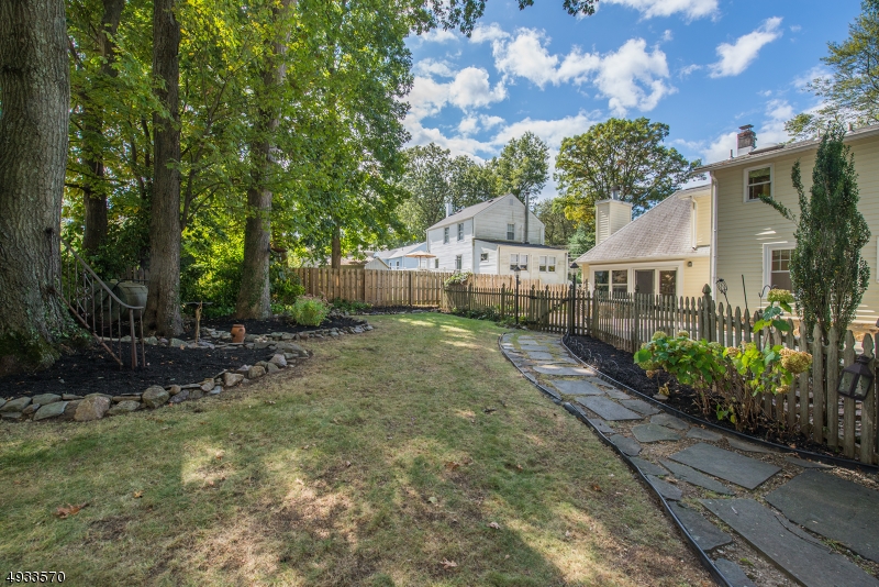 True Pride of ownership in this custom home! Spectacular Colonial nestled in the desirable Indian Lake section. Park Like Setting on Double Lot. Flowing, open concept great for entertaining. Updated, Country kitchen offers a ton of counter/cabinet space. Sun-filled FR is accented w/a gas fireplace & cathedral ceiling. Open DR is highlighted by oversized bay window. Sweet sitting area w/vaulted ceiling & welcoming foyer. 1st floor bdrm, full bath & office. HW floors throughout. 3 addtl bdrms & updated bath on 2nd level. Bright reading nook! Full bonus BSMT- laundry & storage +over-sized 2 car garage & shed. Corner property, beautifully landscaped front & private backyard oasis with patios, stone fireplace & wood fence. Gardener?s delight. Tremendous curb appeal! Walk to lake, DWTN & NYC-direct mass transit.