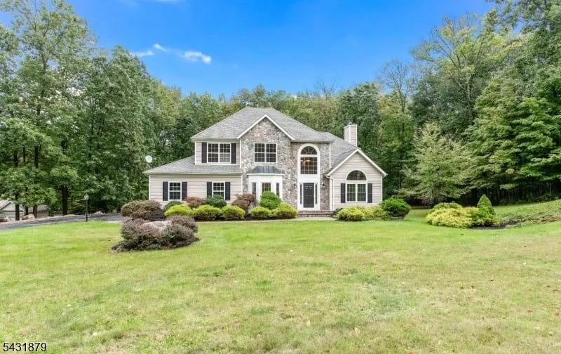 Welcome to this inviting and spacious center hall colonial, perfectly situated on a quiet cul-de-sac close to top-rated schools, shopping, dining, and major commuter routes. Step inside to a bright, dramatic two-story foyer that sets the tone for the rest of the home. The main level boasts a formal living room with vaulted ceilings, elegant French doors, and transom windows, as well as a formal dining room perfect for entertaining. The heart of the home is the center-island kitchen, featuring brand-new stainless steel appliances, updated lighting, granite countertops, and sliders leading out to the deck. Relax in the expansive family room, highlighted by a cozy wood-burning fireplace with a marble surround. A private den/office, powder room, and dedicated laundry room complete the main floor.Upstairs, the luxurious primary suite offers a tray ceiling, two large walk-in closets, and a spa-like en suite bath with a jetted tub and beautiful new flooring. Three additional generously sized bedrooms and a full bath complete the second level. The beautifully finished walk-out basement features a massive recreation room with sliders opening to a paver patio, a serene koi pond, and an expansive yard. Don't miss the opportunity to make this dream home yours!