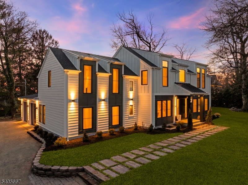 An EXCEPTIONAL, COMPLETELY RE-BUILT home designed by renowned architect Thomas Baio, offering 6 oversized bedrooms and 6.5 baths across three beautifully finished levels, on a fabulous level lot.  The home makes a striking first impression with its modern, maintenance-free facade, standing-seam metal roof accents, and curated architectural lighting. A dramatic double-height foyer with sculptural Sonneman chandelier introduces interiors defined by a refined "quiet luxury aesthetic, wide-plank oak floors, and a cohesive modern neutral palette. Bathed in natural light, the main level features expansive formal living and dining rooms, a spectacular great room with an indoor-outdoor fireplace, and oversized windows. The chef's kitchen is a true showpiece, anchored by a waterfall island in Volupia Green quartzite, custom cabinetry, designer appliances and fixtures, and a fully equipped walk-through pantry and prep kitchen. The first floor also features a private bedroom suite, a mudroom, and a powder room. Upstairs, every bedroom is en-suite, including a serene primary suite with walk-in closets, spa bath finished in Venetian Vendome stone, and a flexible sitting room or office. The finished lower level features a large entertainment lounge with a wet bar, a bedroom, a full bath, a playroom, and bonus spaces. Flat backyard with stone patio and room for pool. Oversized two-car garage, brand-new roof, and mechanical systems. Rare opportunity to own a design-driven, turnkey residence