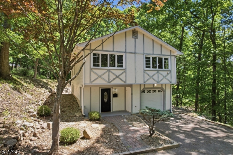 WOW  This is the one you have been waiting for! Welcome to 3 Conklin Avenue, a beautifully updated, move-in ready home nestled on a private wooded lot in Stanhope, NJ. From the moment you arrive, you will appreciate the peaceful setting, outstanding curb appeal, and pride of ownership throughout. Step inside to an inviting foyer that opens to a bright and spacious main level featuring a large living room, formal dining area, stunning updated kitchen, three generously sized bedrooms, and a beautifully renovated full bathroom. The kitchen is truly a showstopper with stainless steel appliances, modern white cabinetry, elegant gold accents, and a designer backsplash. The lower level offers incredible additional living space, including a large family room, a second full bathroom, laundry area, and direct access to the oversized garage. Outside, enjoy a large driveway, private backyard, and tranquil wooded surroundings that provide the perfect blend of privacy and convenience. Ideally located just minutes from Lake Hopatcong, local parks, shopping, dining, and major commuter routes, this home offers everything todays buyers are looking for. Simply unpack your bags and move right in!