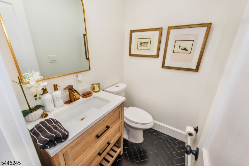 Welcome to this charming 4-bedroom, 1.5-bath Colonial where timeless character meets thoughtful modern updates. Filled with natural light, this inviting home features beautifully preserved 100-year-old hardwood floors, original stained-glass windows framing the fireplace, and an open, flowing layout ideal for both everyday living and entertaining. The spacious, remodeled kitchen boasts soaring angled ceilings and opens seamlessly to the main living areas, while the finished attic provides a versatile fourth bedroom, home office, or playroom. Enjoy year-round comfort with a dual-zone HVAC system, central air, smart thermostats, updated plumbing & newer windows. Additional highlights include custom window shades, a one-car garage, an unfinished basement with abundant storage, and a private back deck perfect for relaxing or entertaining. Located on a quiet, tree-lined street known for its pride of ownership, this home is just moments from DeHart Park, the vibrant Boyden x Jacoby dining district, Maplewood Village, NJ Transit with free parking for an easy NYC commute, and the town's popular shops, restaurants, fairs, and community events. A wonderful opportunity to enjoy the charm, convenience, and strong sense of community that make Maplewood so desirable.