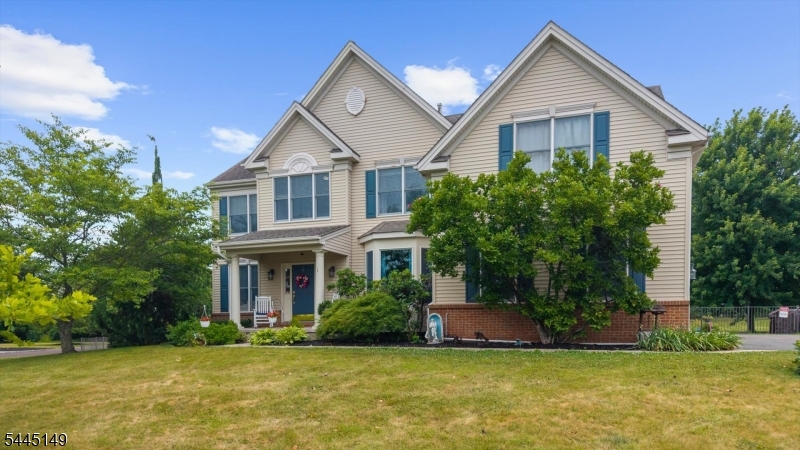 Welcome to desirable Hunterdon Crossing, where this sun-filled Colonial offers exceptional curb appeal, a welcoming rocking chair front porch, and picturesque sunset views. A dramatic two-story foyer opens to elegant formal living and dining rooms, while the spacious family room features a soaring vaulted ceiling and cozy fireplace. The well-appointed kitchen is designed for everyday living and entertaining with granite countertops, center island, pantry, and a bright breakfast area. A private first-floor office, convenient laundry room, and hardwood flooring throughout the main level add to the home's functionality. Upstairs, the luxurious Primary Suite is a true retreat, complete with dual walk-in closets, a sitting room, and a spa-inspired ensuite bath featuring a soaking tub and separate shower. Three additional generously sized bedrooms share a full bath, complemented by a versatile study/lounge area perfect for homework, reading, or a second office. The finished basement expands the living space with recreation and media areas while still offering abundant storage. Set on a beautifully landscaped 1.2-acre lot with a fenced backyard and expansive paver patio, this move-in ready home has been meticulously maintained and is excellent condition. Ideally located just minutes from shopping, dining, and entertainment in Flemington, Lambertville, and Princeton, this exceptional home offers the perfect blend of peaceful country living and everyday convenience.