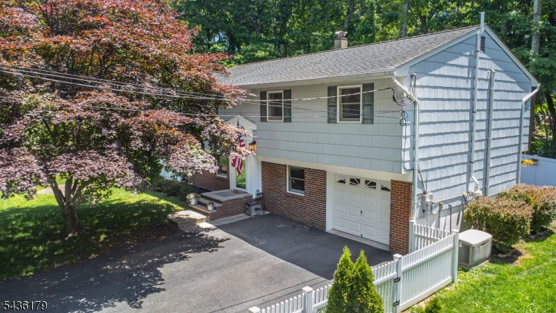 Move right into this beautifully maintained bi-level home nestled on a quiet street in the desirable Stanhope section of Hopatcong. Offering 4 spacious bedrooms with ample closet space, 2 full bathrooms, and an oversized 1-car garage, this home provides flexible living space to meet a variety of needs. Inside, you'll find gorgeous hardwood floors throughout the main level and newer laminate flooring in the lower level, creating a warm and updated feel. The bright and functional layout offers comfortable living and entertaining spaces, while recent improvements provide peace of mind for years to come. Step outside to enjoy the newer paver patio and newer privacy fence, creating the perfect setting for relaxing, entertaining, or enjoying your backyard retreat. Additional updates include a newer 3 bedroom septic system, newer natural gas boiler, and an automatic whole-house generator (natural gas) for added convenience and reliability. Conveniently located near shopping, dining, parks, lakes, and major commuting routes, this well-maintained home combines comfort, updates, and value in a peaceful neighborhood setting. Don't miss this opportunity to make it yours!  *3 Bedroom Septic*