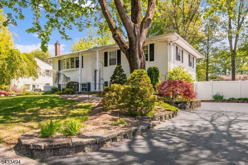 Welcome to the highly desirable White Rock section of Oak Ridge, where comfort, convenience, and natural beauty come together in this 5-bedroom, 2-bath bi-level home. Set on a beautifully landscaped property with mature plantings that provide both privacy and curb appeal, this home offers the perfect blend of indoor and outdoor living. The upper level has been freshly painted and features all new flooring in the bedrooms, with mostly hardwood surfaces adding warmth and timeless appeal throughout the space. The bright and functional layout is ideal for everyday living as well as entertaining. Off the dining area, a beautiful 4-season room overlooks the backyard and provides access to the deck, creating the perfect space for morning coffee, relaxing year-round, or hosting guests while enjoying peaceful outdoor views. Step outside to enjoy the fully fenced backyard with brand-new vinyl fencing, updated deck railings, and two stairways provide easy access to the yard perfect for gatherings, play space, pets, or simply relaxing outdoors. Additional highlights include a brand new roof with warranty, public water and sewer, a Generac whole house generator, and natural gas available in the street for future connection. Conveniently located near parks, schools, shopping, dining, and major commuting routes, this home offers both tranquility and accessibility in one of Oak Ridge's most sought-after neighborhoods.
